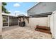 The backyard boasts brick pavers, a grill, screened in porch, and lots of greenery at 8203 Kirkwood Dr, Tampa, FL 33634
