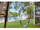 Lush backyard featuring a swing set, with views of the lake, fountain, and custom stairs at 8203 Kirkwood Dr, Tampa, FL 33634