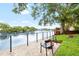 Lakeside patio featuring a fire pit, seating, and stunning water views at 8203 Kirkwood Dr, Tampa, FL 33634