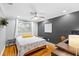 Cozy bedroom with hardwood floors, accent wall, and modern decor at 8203 Kirkwood Dr, Tampa, FL 33634