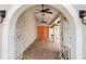 Inviting view of an orange double door, visible through the arched gate at 8203 Kirkwood Dr, Tampa, FL 33634