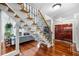 Elegant entryway featuring hardwood floors, staircase, and a glimpse of the living area at 8203 Kirkwood Dr, Tampa, FL 33634