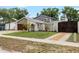 Charming home featuring manicured lawn, stone accents, and a driveway at 8203 Kirkwood Dr, Tampa, FL 33634