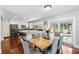 Open kitchen and dining area with a large island and seating, plus a view of the swimming pool at 8203 Kirkwood Dr, Tampa, FL 33634