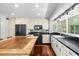 Bright kitchen featuring sleek black appliances, granite countertops, and ample natural light at 8203 Kirkwood Dr, Tampa, FL 33634