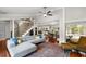 Open-concept living space featuring a fireplace, hardwood floors, and comfortable seating at 8203 Kirkwood Dr, Tampa, FL 33634