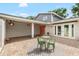 Exterior patio features elegant brickwork, an outdoor seating area, and hanging flower baskets at 8203 Kirkwood Dr, Tampa, FL 33634