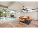 Covered patio with dining area overlooking screened-in pool at 8203 Kirkwood Dr, Tampa, FL 33634