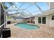 Relaxing pool area featuring a screened enclosure, brick pavers, and covered dining space at 8203 Kirkwood Dr, Tampa, FL 33634