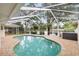 Screened-in pool with patio and outdoor living space at 8203 Kirkwood Dr, Tampa, FL 33634
