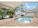 Serene pool area with lush tropical landscaping and a clear view of the lake with fountain at 8203 Kirkwood Dr, Tampa, FL 33634