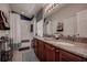 Bathroom featuring double sinks with granite countertops and cherry wood cabinets at 8447 Shallow Creek Ct, New Port Richey, FL 34653