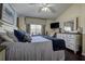 Comfortable bedroom with blue accents, natural light and decorative furniture at 8447 Shallow Creek Ct, New Port Richey, FL 34653
