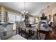 Elegant dining room with a large table, stylish chairs, and ample natural light, perfect for gatherings and meals at 8447 Shallow Creek Ct, New Port Richey, FL 34653