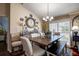 Elegant dining room featuring a wooden table, decorative wall plates, and a modern chandelier at 8447 Shallow Creek Ct, New Port Richey, FL 34653