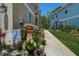 Sidewalk view of townhomes with colorful garden and decor at 8447 Shallow Creek Ct, New Port Richey, FL 34653