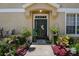Inviting front entrance with lush landscaping, a welcoming door, and stylish decor, creating a warm and pleasant arrival at 8447 Shallow Creek Ct, New Port Richey, FL 34653