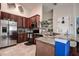 Well-equipped kitchen with stainless steel appliances, granite countertops, and stylish cherry wood cabinets at 8447 Shallow Creek Ct, New Port Richey, FL 34653