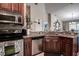 Spacious kitchen with granite countertops, stainless steel appliances, and cherry wood cabinetry at 8447 Shallow Creek Ct, New Port Richey, FL 34653