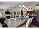 Open-concept living and dining area with modern lighting, hardwood floors, and a cozy fireplace for comfortable living at 8447 Shallow Creek Ct, New Port Richey, FL 34653