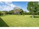 Expansive backyard with lush green grass and mature trees, perfect for outdoor activities at 9313 Lisbon St, Seffner, FL 33584