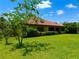 Well-maintained backyard with lush lawn and mature landscaping offering a serene outdoor space at 9313 Lisbon St, Seffner, FL 33584