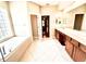 Spacious bathroom with dual sink vanity, soaking tub, tile floor and natural light at 9313 Lisbon St, Seffner, FL 33584