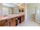 Bright bathroom with a double sink vanity, glass-enclosed shower, and a large mirror at 9313 Lisbon St, Seffner, FL 33584