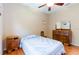 Cozy bedroom with hardwood floors, a ceiling fan, and vintage-style furniture at 9313 Lisbon St, Seffner, FL 33584