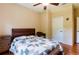 Comfortable bedroom featuring wood floors, a ceiling fan, and a well-lit interior at 9313 Lisbon St, Seffner, FL 33584