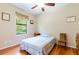 Traditional bedroom showcasing hardwood floors and a window providing natural light at 9313 Lisbon St, Seffner, FL 33584