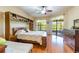Spacious bedroom featuring wood floors, a ceiling fan, and sliding glass doors to an outdoor area at 9313 Lisbon St, Seffner, FL 33584