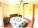 Cozy bedroom with a wood-frame bed, hardwood floors, and a ceiling fan at 9313 Lisbon St, Seffner, FL 33584