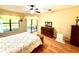 Bright bedroom featuring hardwood floors, ceiling fan and a view to the outdoor patio at 9313 Lisbon St, Seffner, FL 33584