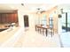 Bright dining area features a wooden table, tile flooring, and is adjacent to the kitchen at 9313 Lisbon St, Seffner, FL 33584