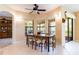 Dining area with wooden table, six chairs, tile flooring and windows overlooking the patio at 9313 Lisbon St, Seffner, FL 33584
