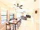 Open dining area with a wood table, ceiling fans, and an abundance of natural light from large windows at 9313 Lisbon St, Seffner, FL 33584