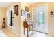 Welcoming foyer with decorative glass door, window, and charming wooden writing desk at 9313 Lisbon St, Seffner, FL 33584
