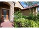 Charming front entrance with brick walkway, stone accents, and lush landscaping surrounding the doorway at 9313 Lisbon St, Seffner, FL 33584