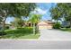Charming single-story home featuring a three car garage, tile roof, and manicured front lawn at 9313 Lisbon St, Seffner, FL 33584