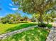 Beautiful home with lush landscaping, mature trees, and a well-maintained lawn at 9313 Lisbon St, Seffner, FL 33584