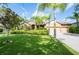 Beautiful home with a well-manicured lawn, mature palm trees, and a three-car garage at 9313 Lisbon St, Seffner, FL 33584