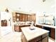Bright kitchen with an island, tile backsplash, custom cabinets and modern appliances at 9313 Lisbon St, Seffner, FL 33584