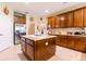 Traditional kitchen with an island, stainless steel refrigerator and lots of cabinet space at 9313 Lisbon St, Seffner, FL 33584