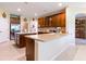 Open kitchen with an island, lots of counter space, tile floors and warm neutral paint at 9313 Lisbon St, Seffner, FL 33584