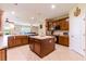 Eat-in kitchen featuring an island, stainless steel appliances, warm cabinets and a ceiling fan at 9313 Lisbon St, Seffner, FL 33584