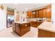 Spacious kitchen featuring an island, tile floors, stainless steel appliances and wooden cabinets at 9313 Lisbon St, Seffner, FL 33584