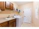 Well-equipped laundry room with a sink, washer, dryer, and ample cabinet space at 9313 Lisbon St, Seffner, FL 33584