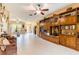 Spacious living room with custom wooden shelves, tile floors and multiple ceiling fans at 9313 Lisbon St, Seffner, FL 33584
