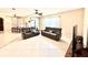 Inviting living room showcasing dual reclining sofas, tile flooring, and a cozy, open-concept design at 9313 Lisbon St, Seffner, FL 33584